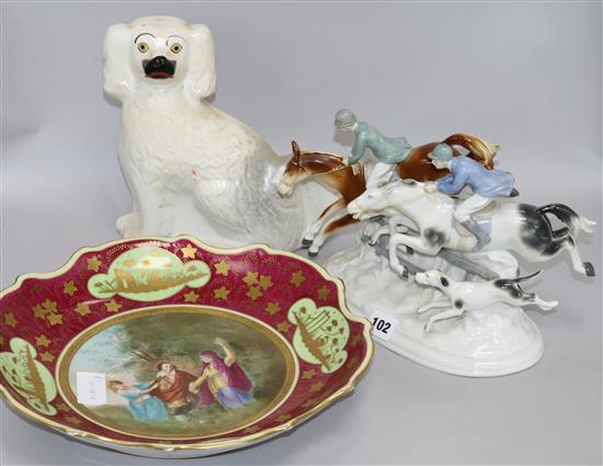 A Sitzendorf hunting group, a Vienna style dish and a Staffordshire spaniel group height 20cm width 25cm